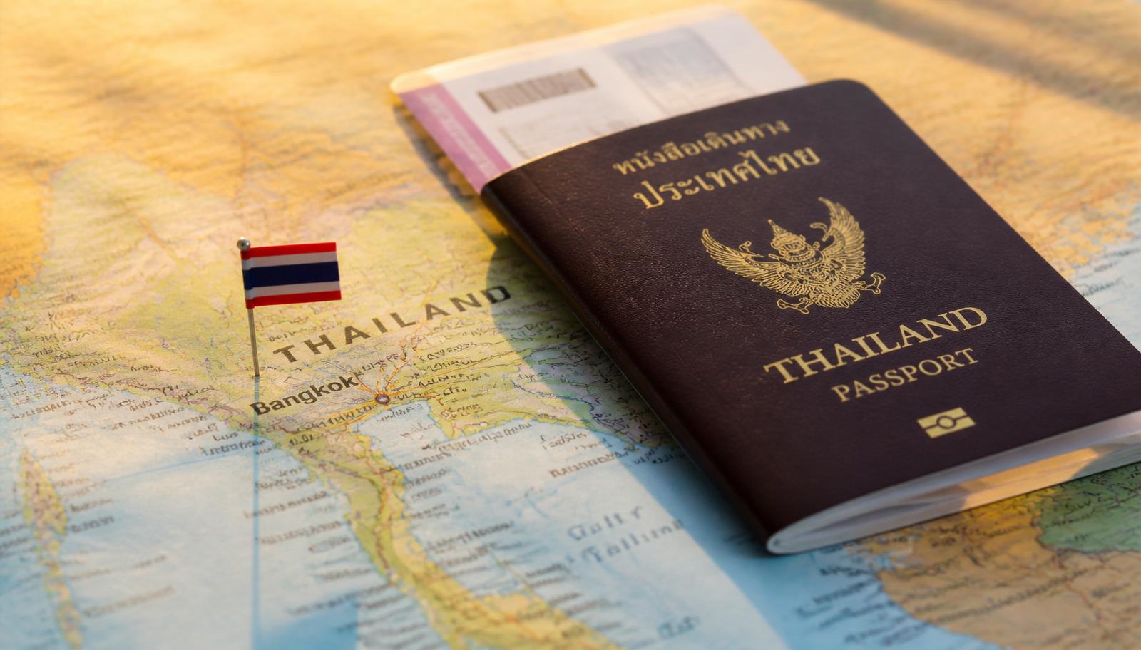 Thai passport and boarding pass on a map of Thailand, illustrating the 2026 visa exemption changes.